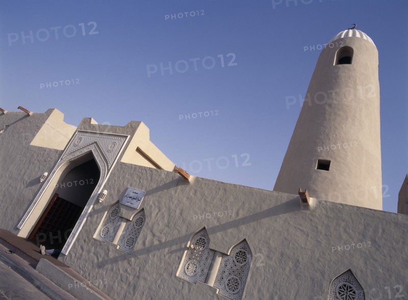 QATAR, Doha, Angled view of Small Mosque in the old souk area showing front entrance and minaret.