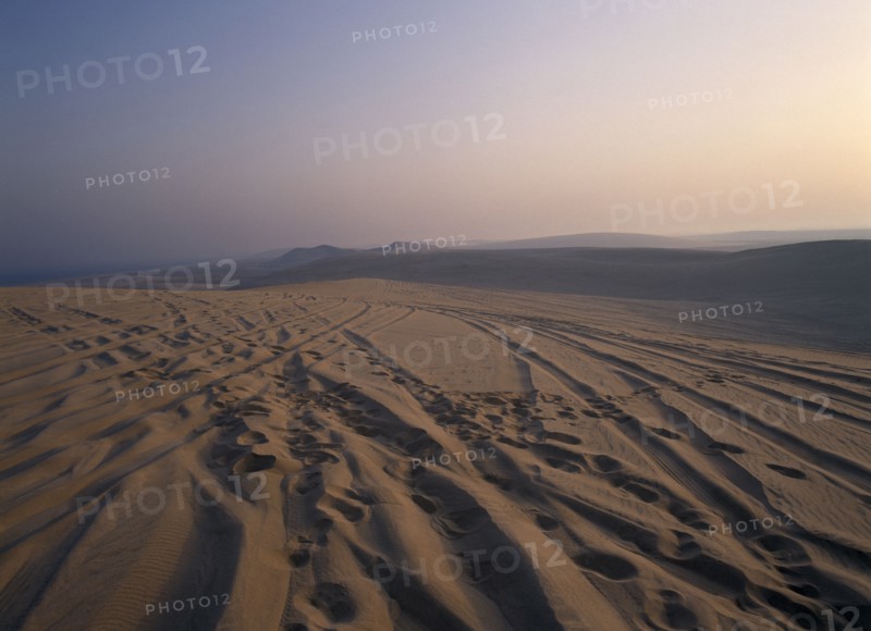 QATAR, South East, Desert, View over sand dunes at sunset near the Sealine Resort.