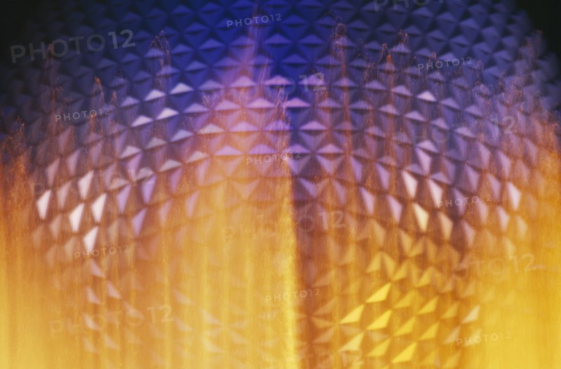 USA, Florida, Orlando, Walt Disney World Epcot Center Spaceship Earth illuminated through fountain