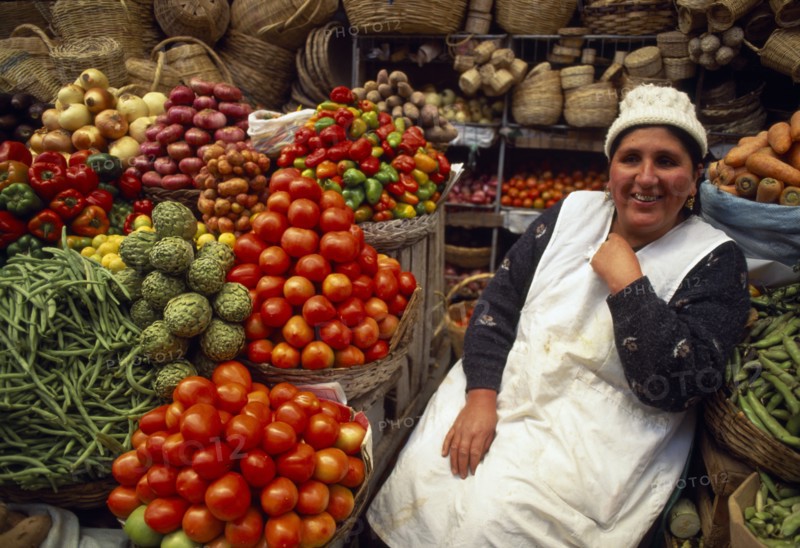 BOLIVIA,  , Sucre, Fruit and vegetable stall and smiling woman vendor.
