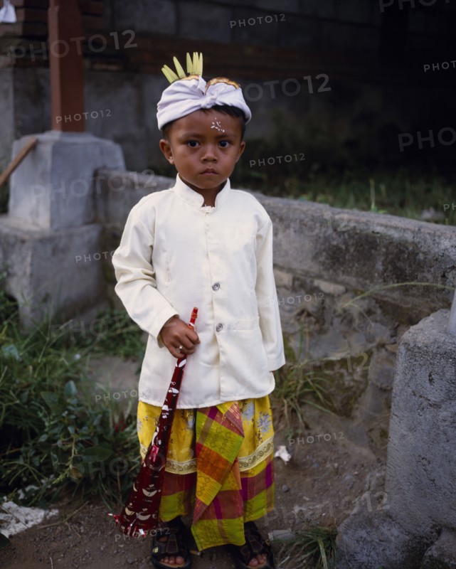 INDONESIA, Bali  , Mas, Young boy in traditional dress for Kuningan Festival