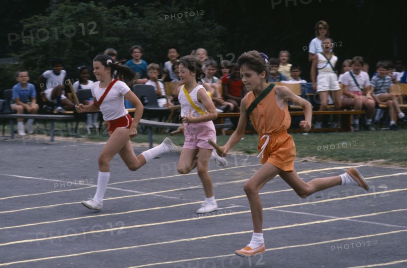 10070351 SPORT  Athletics Track Children competing in relay race.
