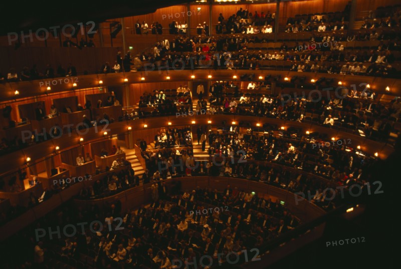 ENGLAND, East Sussex, Glyndebourne, Interior of auditorium with audience members taking their seats before Opera performance.