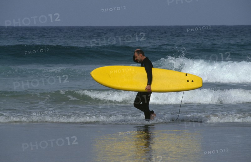 ENGLAND, Cornwall, Newquay, Surfer on Fistral Beach