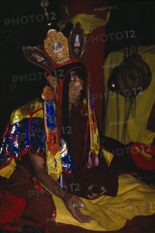CHINA, Tibet  , Lhasa, Brightly dressed Monk chanting