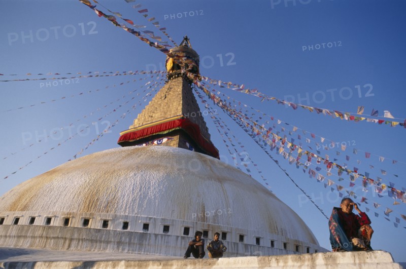 10072366 NEPAL Kathmandu Valley Bodhnath Part view of stupa hung with prayer flags and pilgrims.