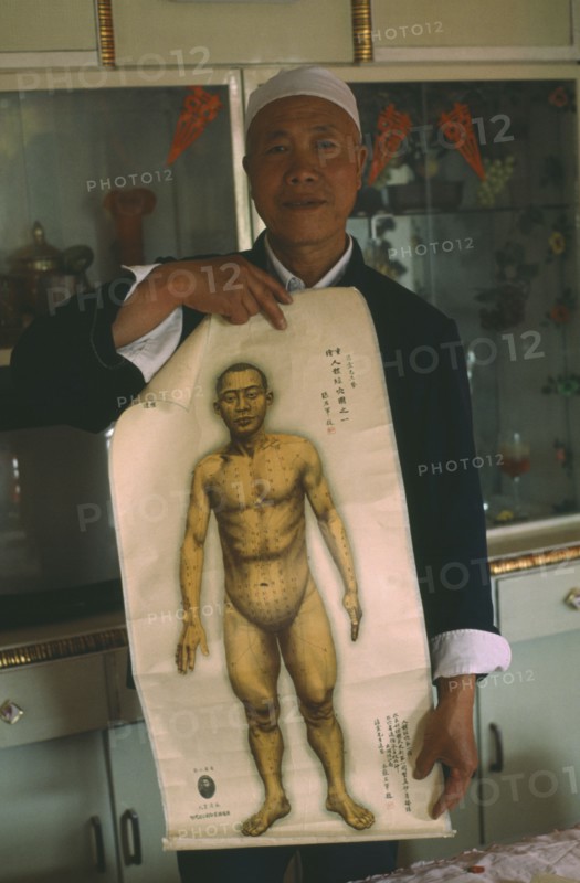CHINA, Gansu, Lanzhou , Acupuncturist holding a chart