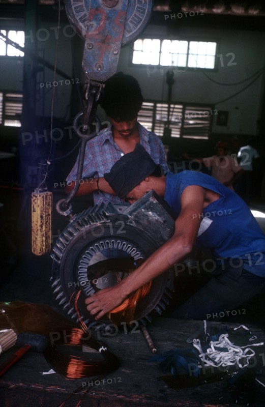 CUBA, Mariel, "Light industry, man in workshop fitting copper wire on to reel"