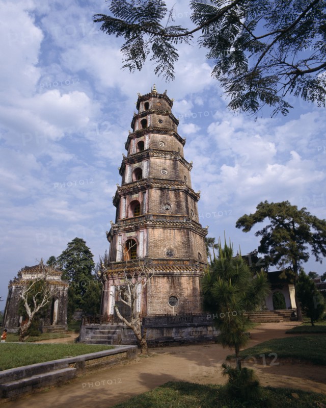 VIETNAM, Central, Hue, "Thien Mu Pagoda,tiered brickwork,mottled sky,overhanging branch "