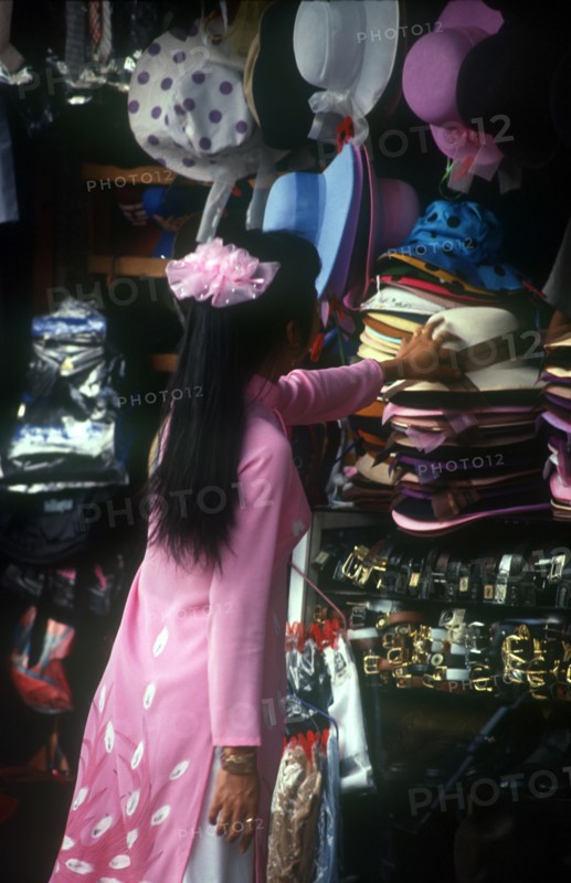 VIETNAM, Ho Chi Minh City, Central Market Woman Buying Hat    Saigon