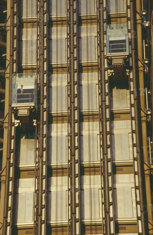 ENGLAND, London, Lloyds Building lifts with passenger on building exterior.