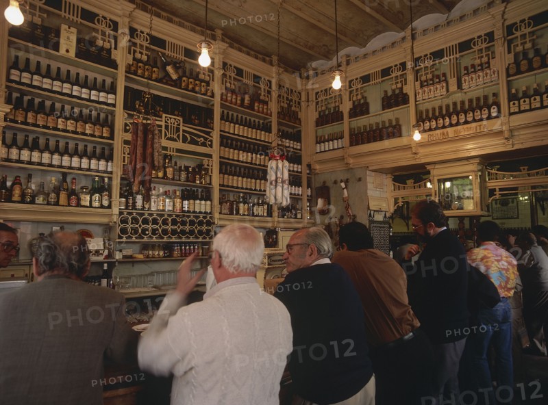 SPAIN, Andalucia, Seville, "Macarena District, El Rinconcillo where Tapas originated with people at the bar counter inside "