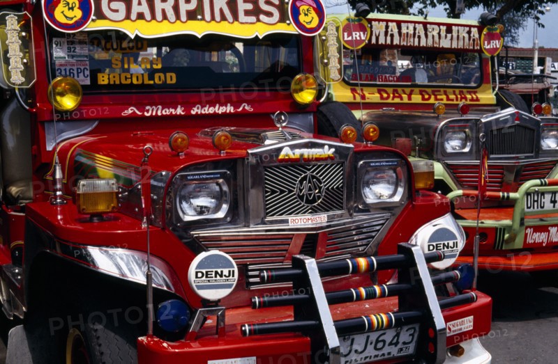 PHILIPPINES, Visayan Islands, Negros, Victorias. Close up of two brightly painted Jeepneys