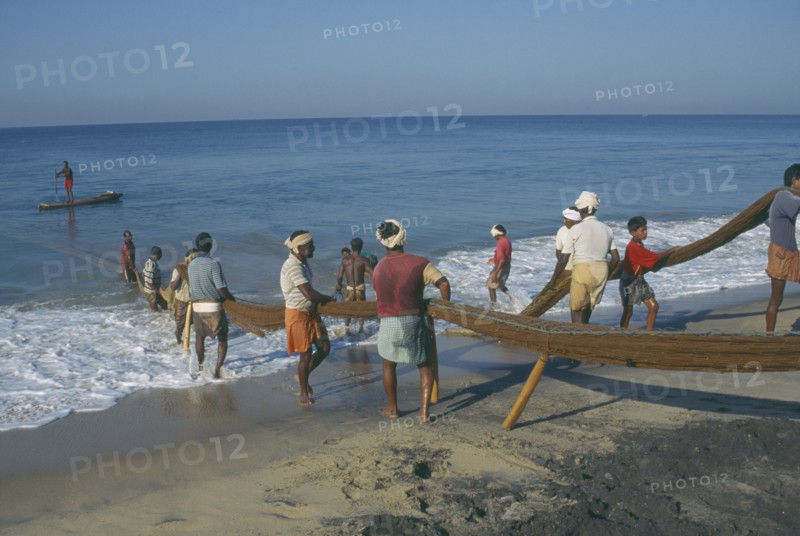 INDIA, Kerala , Varkala, Fisherman landing fish on beach.