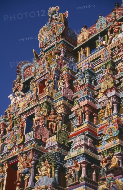 INDIA, Tamil Nadu, Madurai, Sri Meenakshi Temple detail of brightly coloured gopuram exterior wall carvings