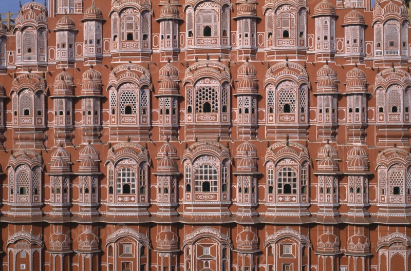 INDIA, Rajasthan, Jaipur, "Hawa Mahal or Palace of the Winds, constructed in 1799.  Cropped view of pink, semi-octagonal, honeycombed sandstone facde. "