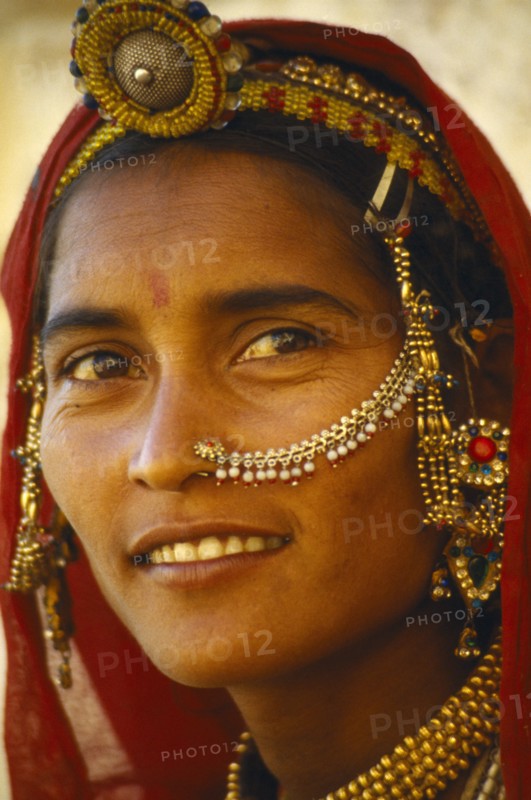 INDIA, Rajasthan, Body Decoration, Portrait of woman with ornate head and nose jewellery.
