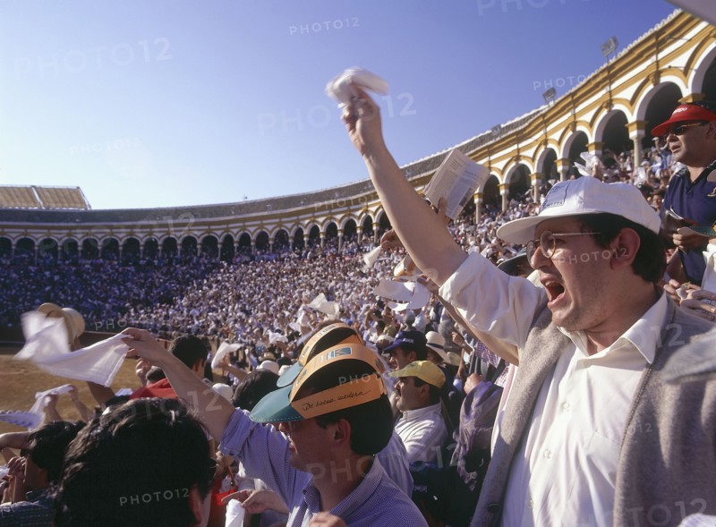 SPAIN, Andalucia, Seville, "Arenal District, white handkerchiefs being waved by the crowd in the stands in the bullring"