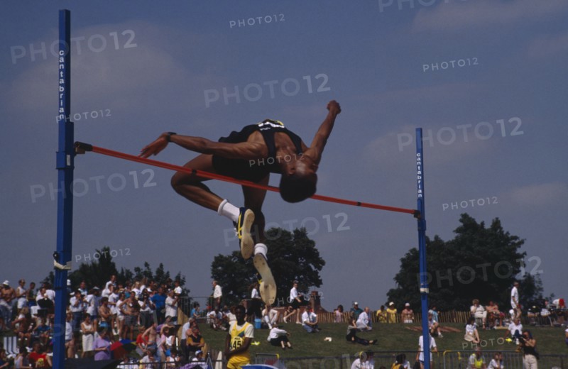 10048207 SPORT Athletics High Jump Competitor in men s high jump clearing bar.