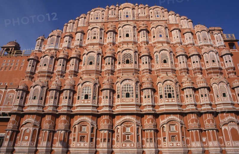 INDIA, Rajasthan, Jaipur, "Hawa Mahal or Palace of the Winds.  Cropped view of semi-octagonal, honeycombed pink sandstone exterior facade."