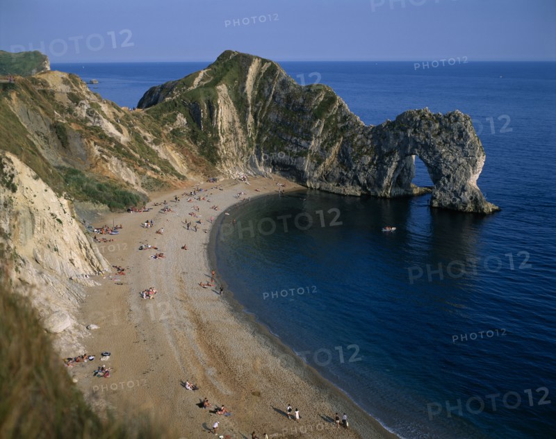 ENGLAND, Dorset, Durdle Door, View over the beach toward eroded coastal arch.