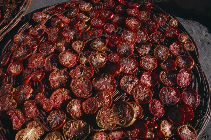 PAKISTAN, Hunza, Karimabad, "Sun dried tomatoes in large, shallow baskets."