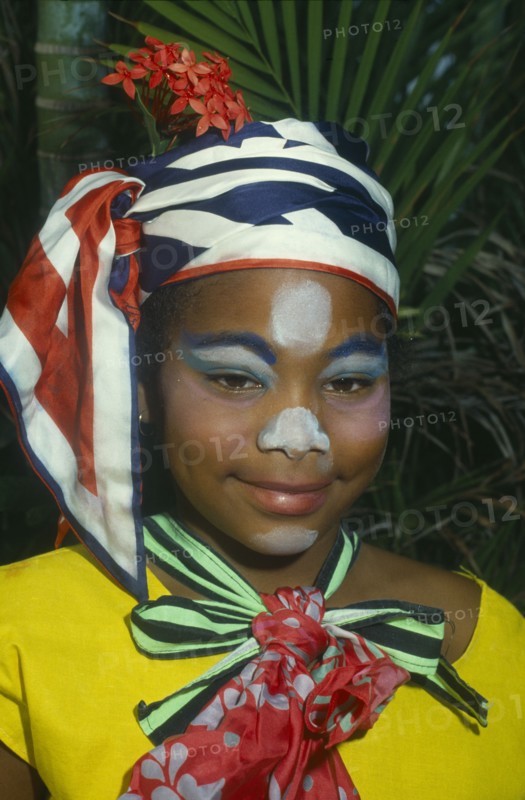 JAMAICA, Carnival, Head and shoulders portrait of girl in costume and face paint.
