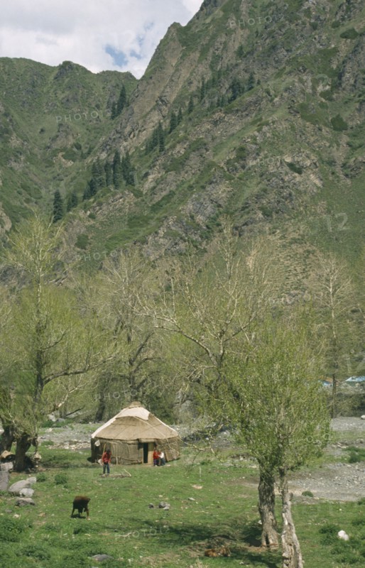 CHINA, Xinjiang, Tanchi, Kazak Yurt. Tent house with family outside