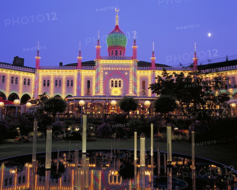 DENMARK, Zealand, Copenhagen, Tivoli Gardens buildings illuminated at night