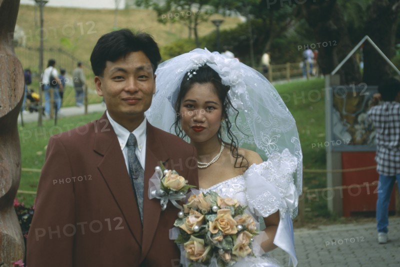 HONG KONG, Central, Hong Kong Park, "Fashionable western style wedding.  Bride and groom, head and shoulders portrait."