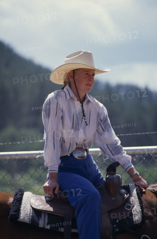 USA, South Dakota, Deadwood, Cowgirl sitting on horse at the Days Of 76 rodeo