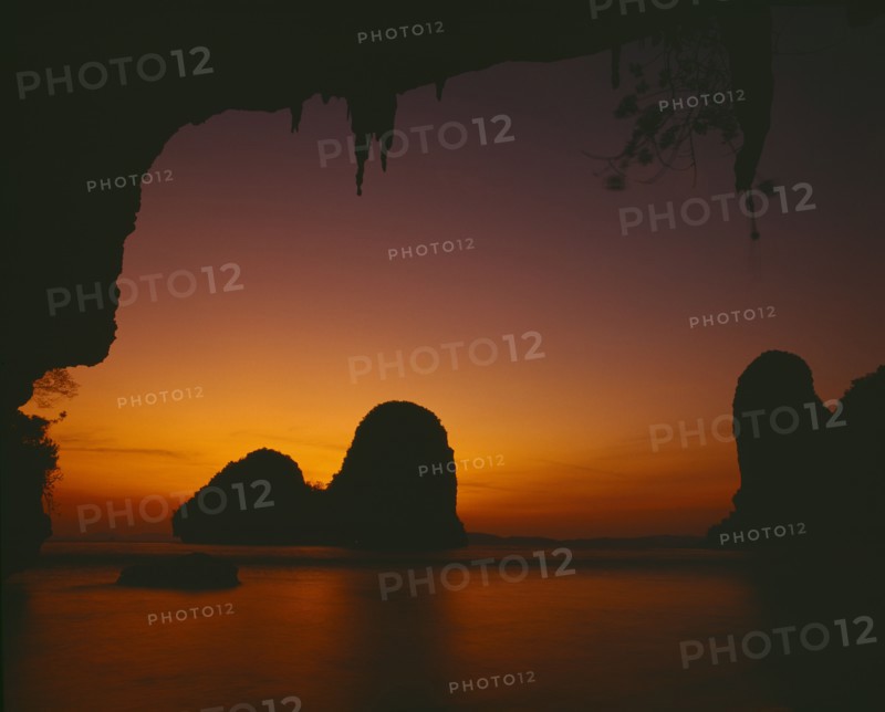 THAILAND, South, Krabi, "Phra Nang beach, orange sunset behind rock formations in the sea "