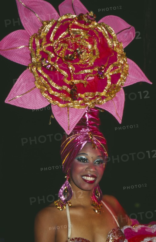 CUBA, Havana Province, Havana, Tropicana Club female dancer in pink costume with pink head-dress in the shape of a flower