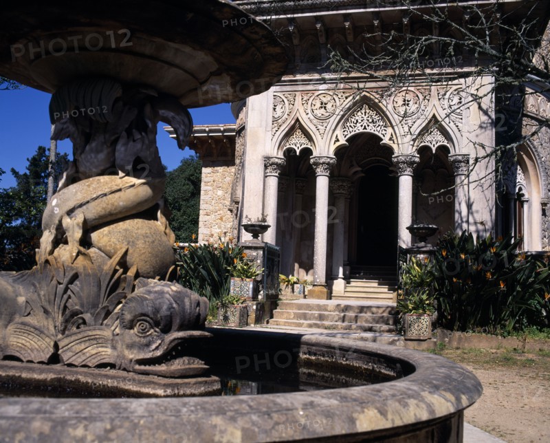 PORTUGAL, Estremadura, Sintra, Monserrate Palace .Courtyard fountain in foreground entrance beyond