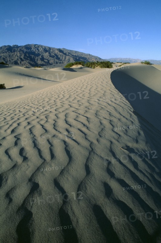 USA, California, Death Valley, Desert landscape leading to rocky hills