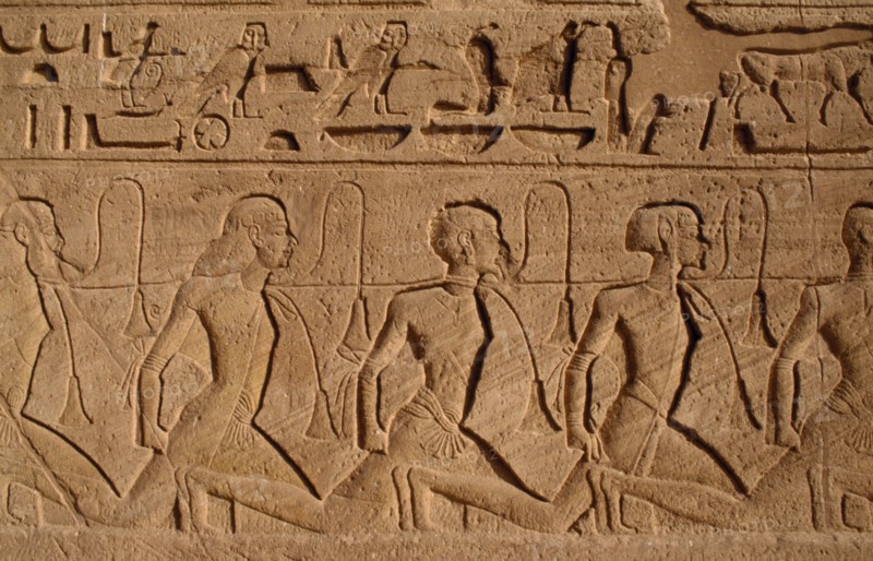 EGYPT, Abu Simbel, Hieroglyphics above relief carving of Nubian slaves