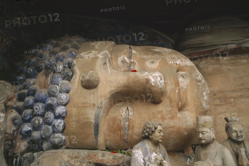 CHINA, Sichuan, Baoding, Tang Dynasty reclining sleeping Buddha depicting the state of achieving nirvana carved into the cliff at Dazu