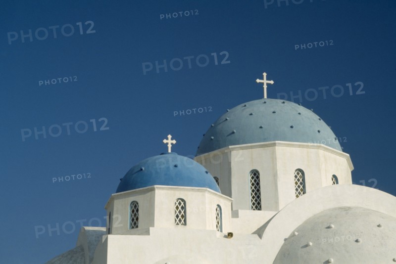 GREECE, Cyclades Islands, Santorini, Perissa.  Blue domed rooftops of white painted church.
