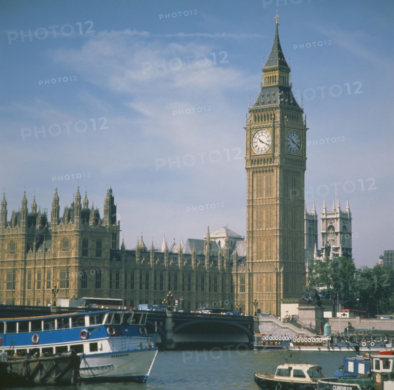 ENGLAND, London, Houses of Parliament Big Ben with the River Thames & boats in the foreground