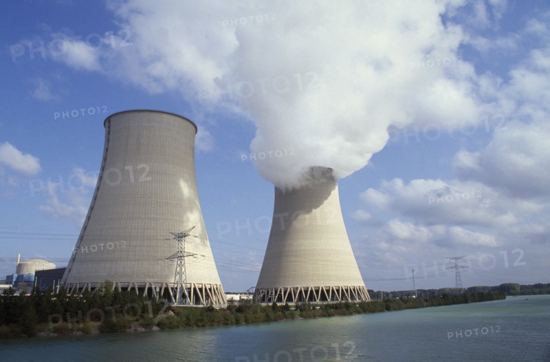 FRANCE, Champagne Ardenne, Aube, "Nogent, Seine Valley.  Nuclear power station cooling towers beside water, emitting smoke"