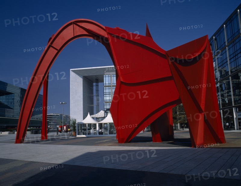 FRANCE, Ile de France, Paris, La Défense.  La Grande Arche framed by red modern sculpture.