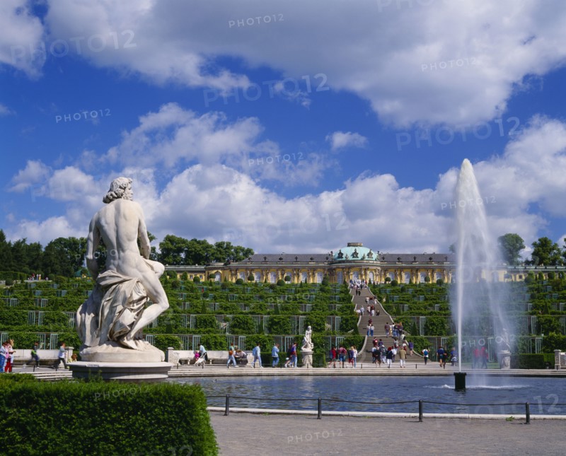 GERMANY, Brandenberg, Potsdam, "Sanssouci Park, terraced steps and topiary leading to the Palace with fountain and statues in the foreground."