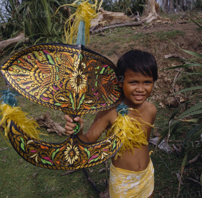 MALAYSIA, Kelantan, Kota Baharu, Malay boy holding multicoloured kite