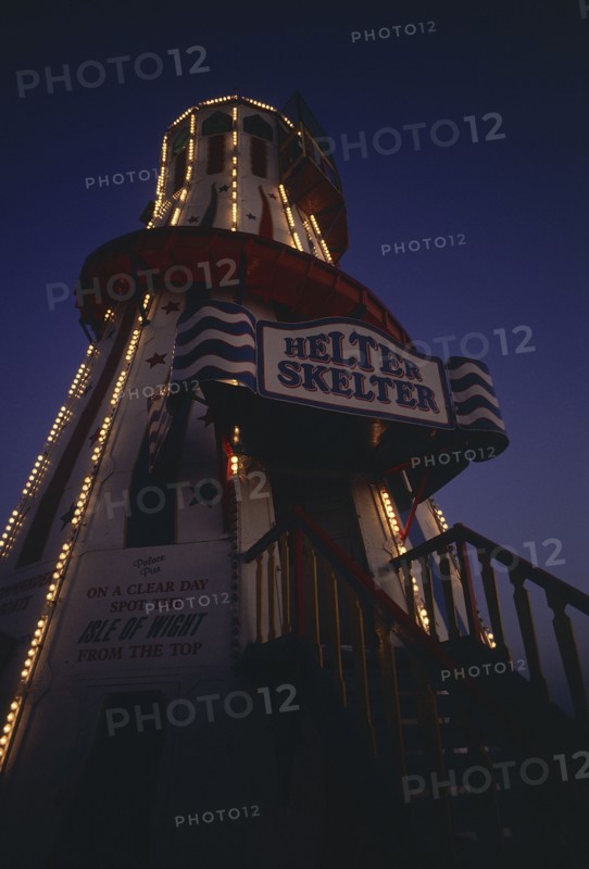 ENGLAND, East Sussex, Brighton, The helter skelter on Brighton Pier illuminated at night