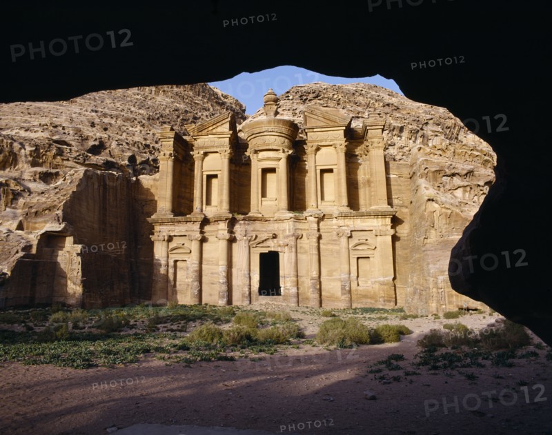 JORDAN, Petra, The Monastery carved from rock face framed by rock arch.