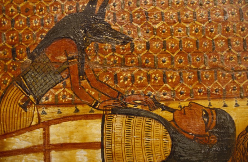 EGYPT, Cairo, Painting on wooden coffin. Jackal Headed God Anubis over reclining figure