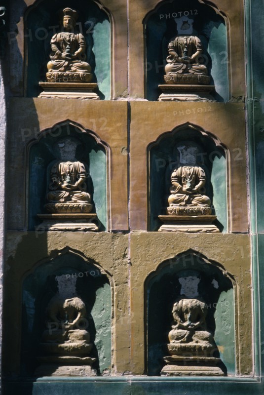 CHINA, Beijing, Summer Palace, Detail of  wall statues with the heads missing from all but one