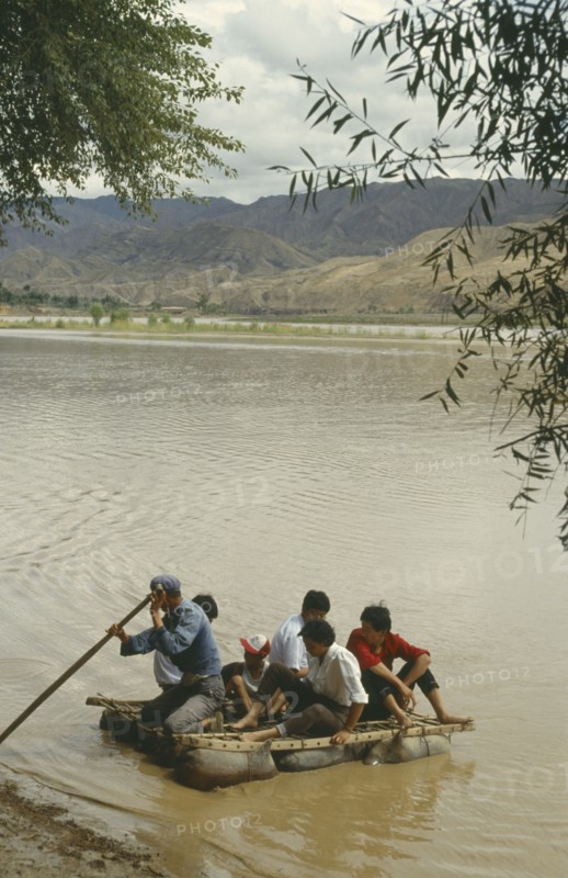 CHINA, Yellow River, People traveling off on a Hide Raft