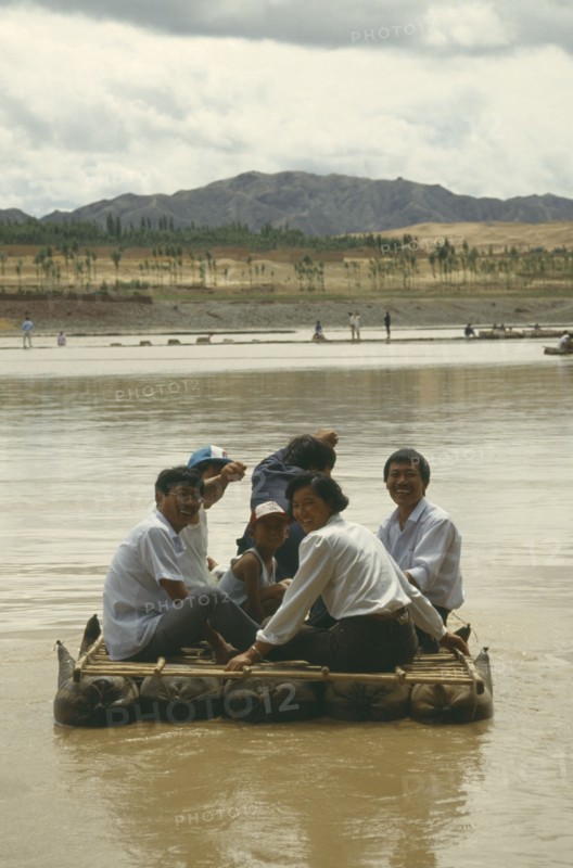 CHINA, Yellow River, People traveling down river on Hide Raft