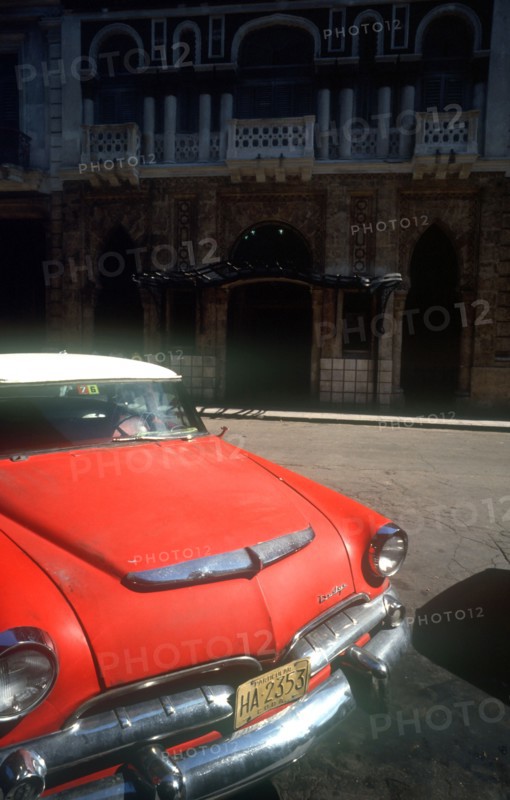 CUBA, Havana, Detail of red US style car parked on Old Havana street.